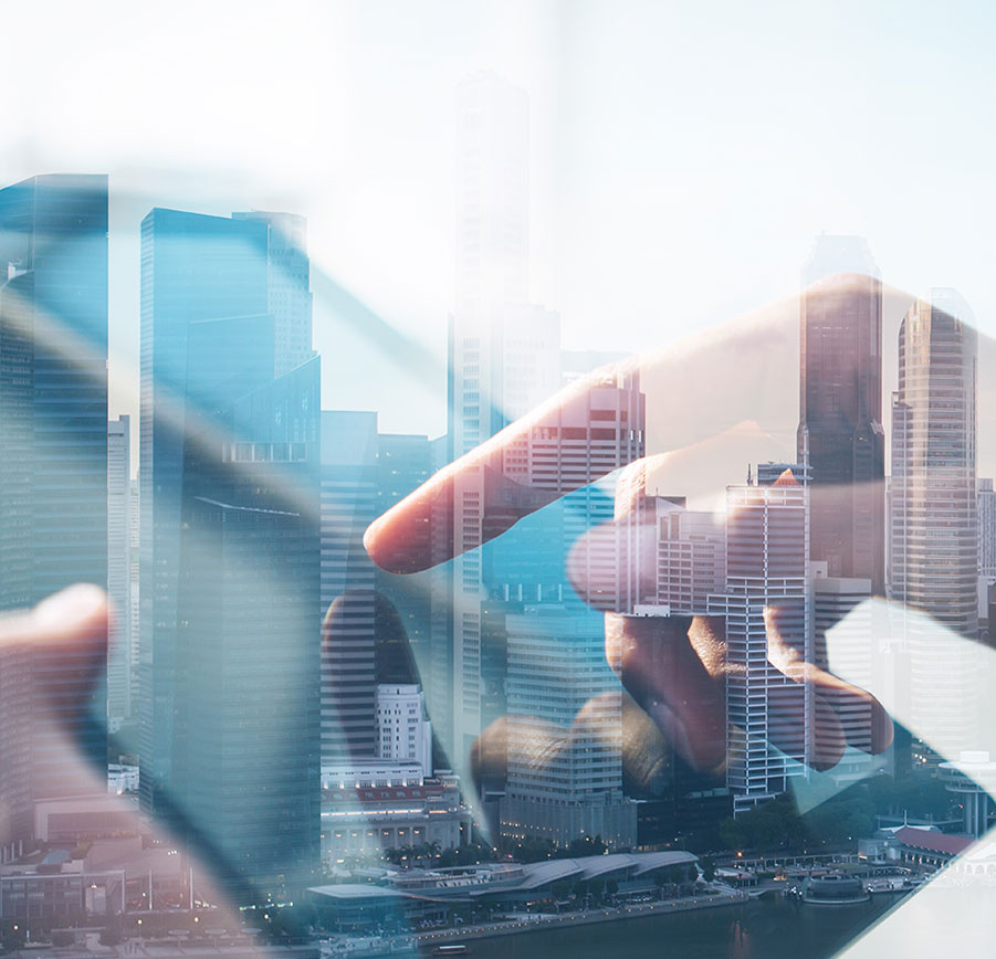 double exposure of city and hands using a tablet